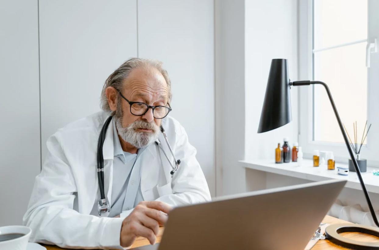 Doctor in a Video Conference Using a Laptop