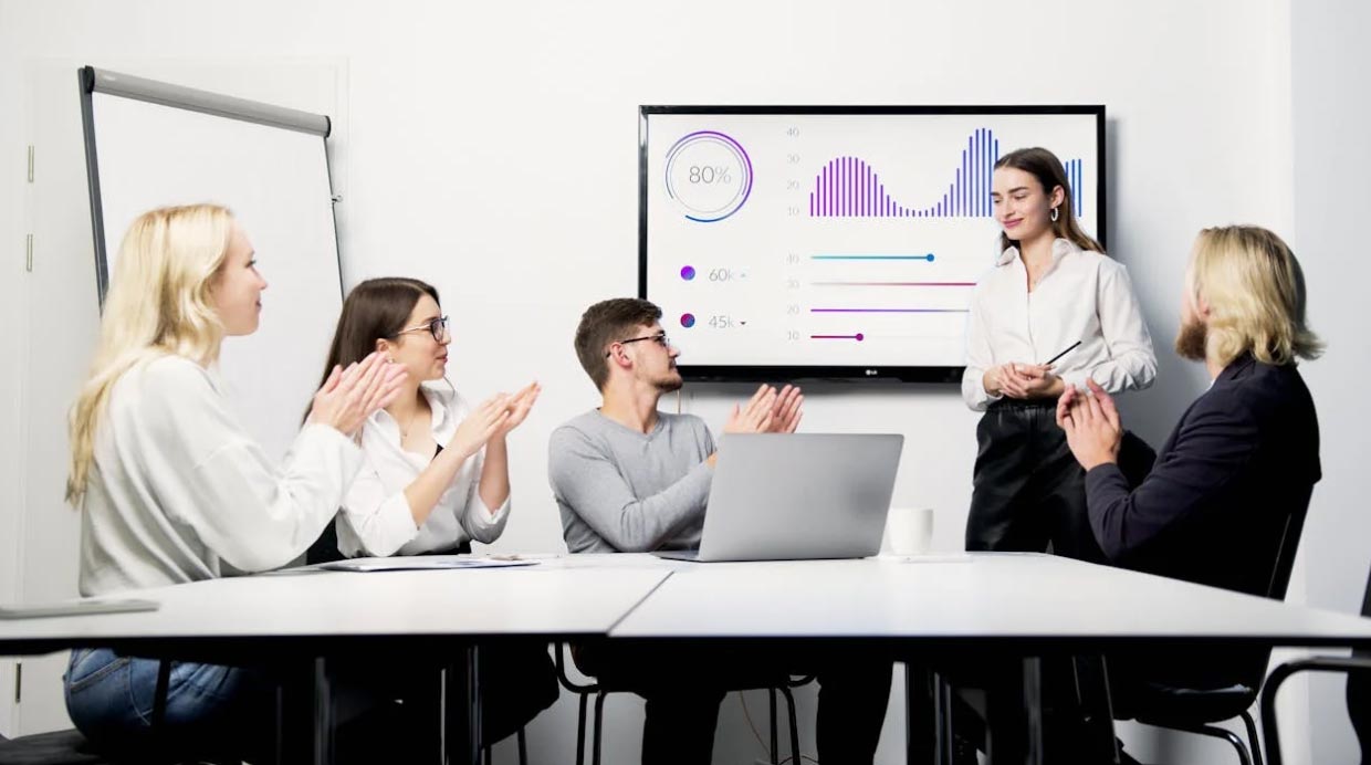 Woman Presenting a Graph on Screen with Success Rate