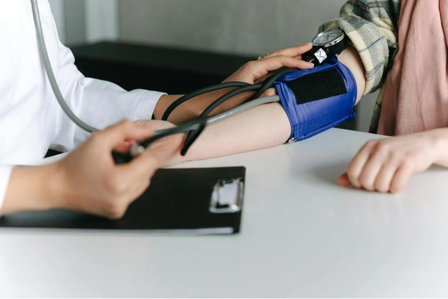 a nurse measuring a patient's blood pressure