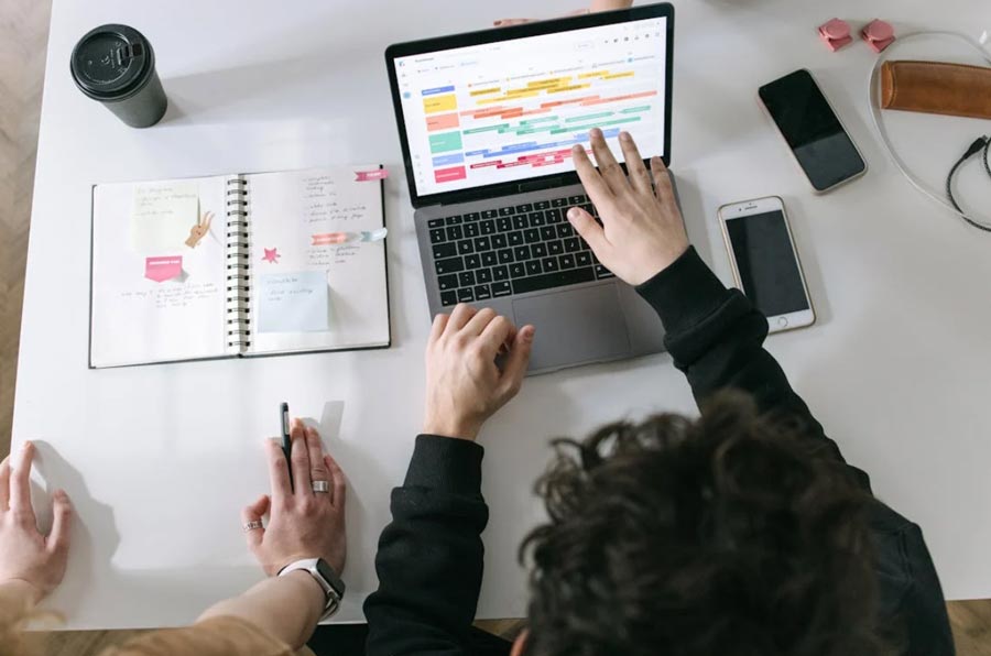 person in black long sleeve shirt using macbook pro