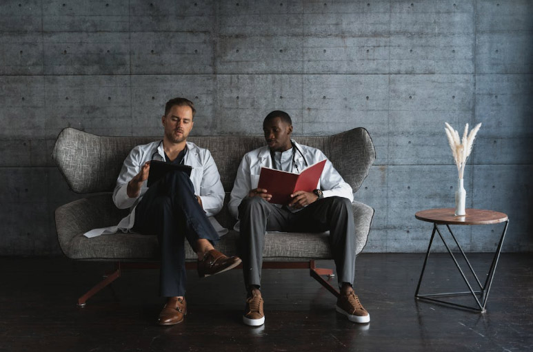 Man and Woman Sitting on Gray Sofa