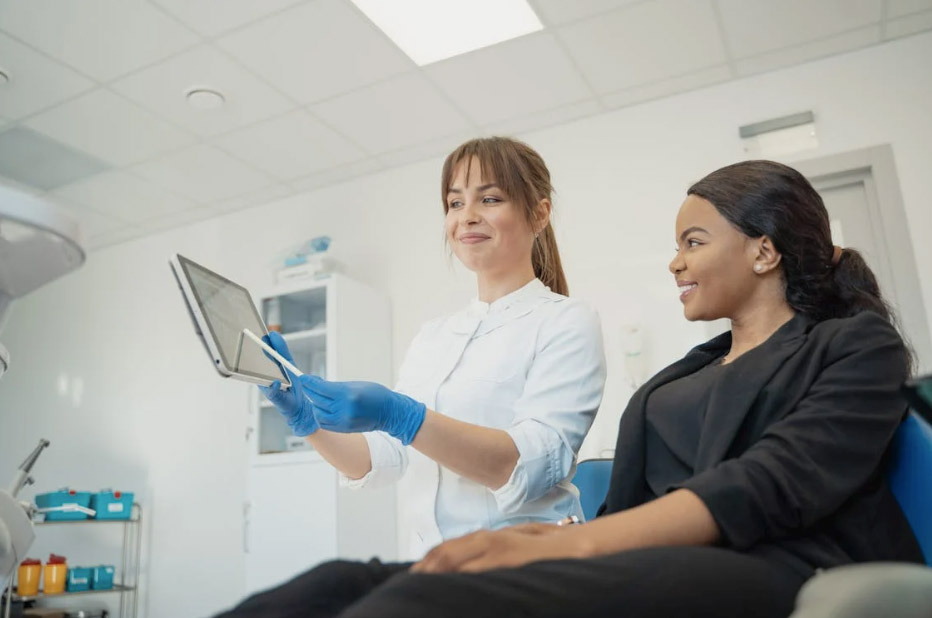 woman in white dress shirt holding ipad