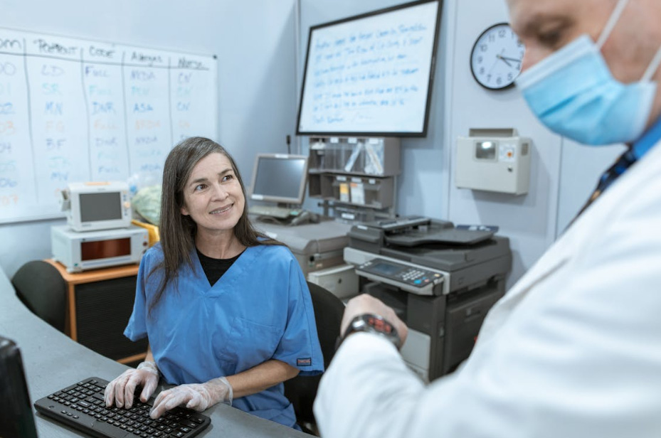 nurse smiling while looking at a doctor