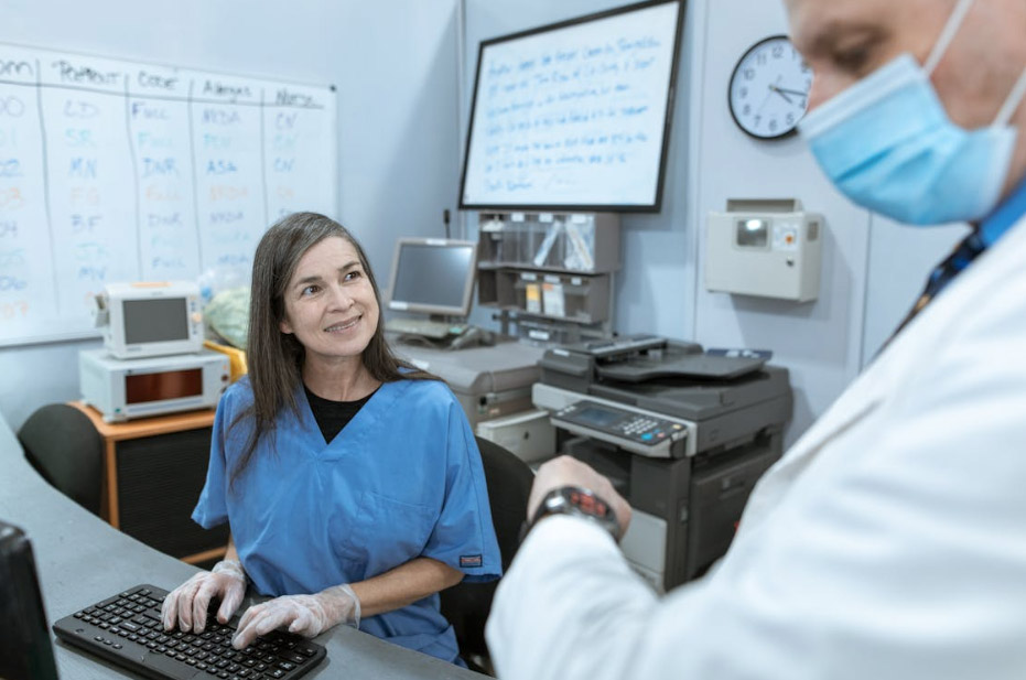 nurse smiling while looking at a doctor