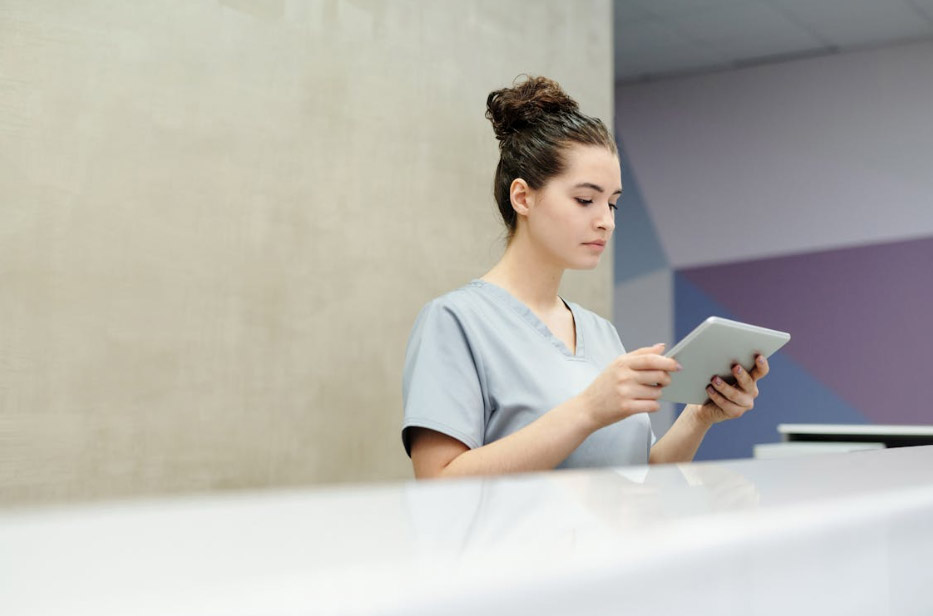 receptionist looking at a tablet