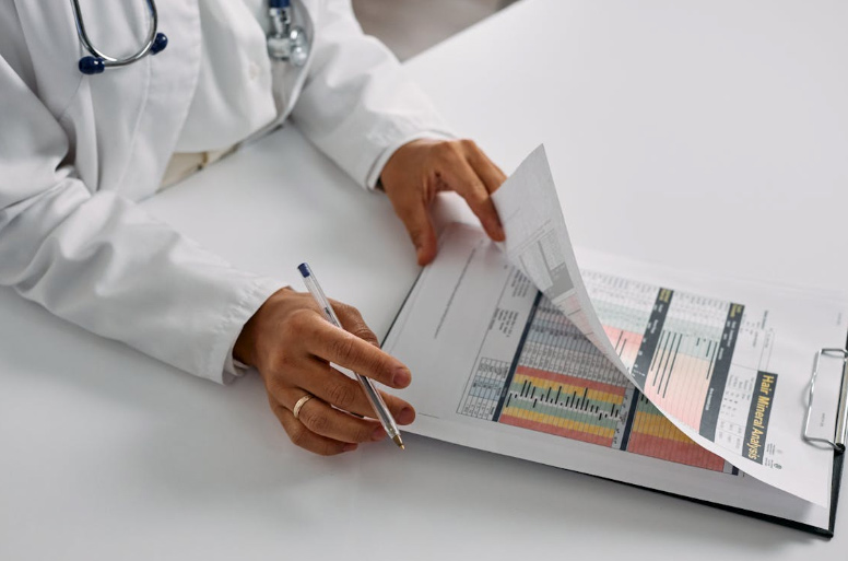  Hands of Doctor Holding Notepad and Pen
