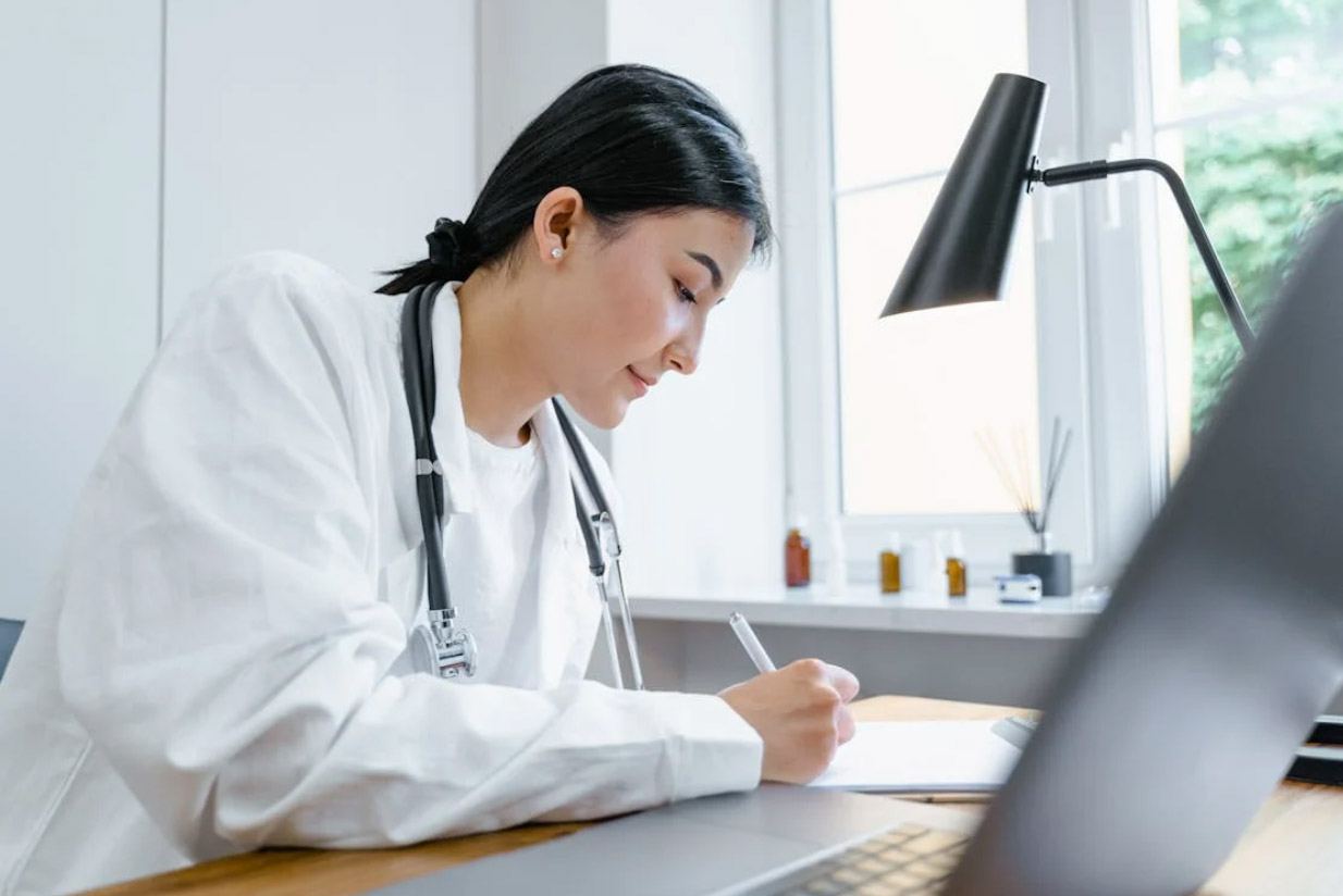 Woman writing patient data