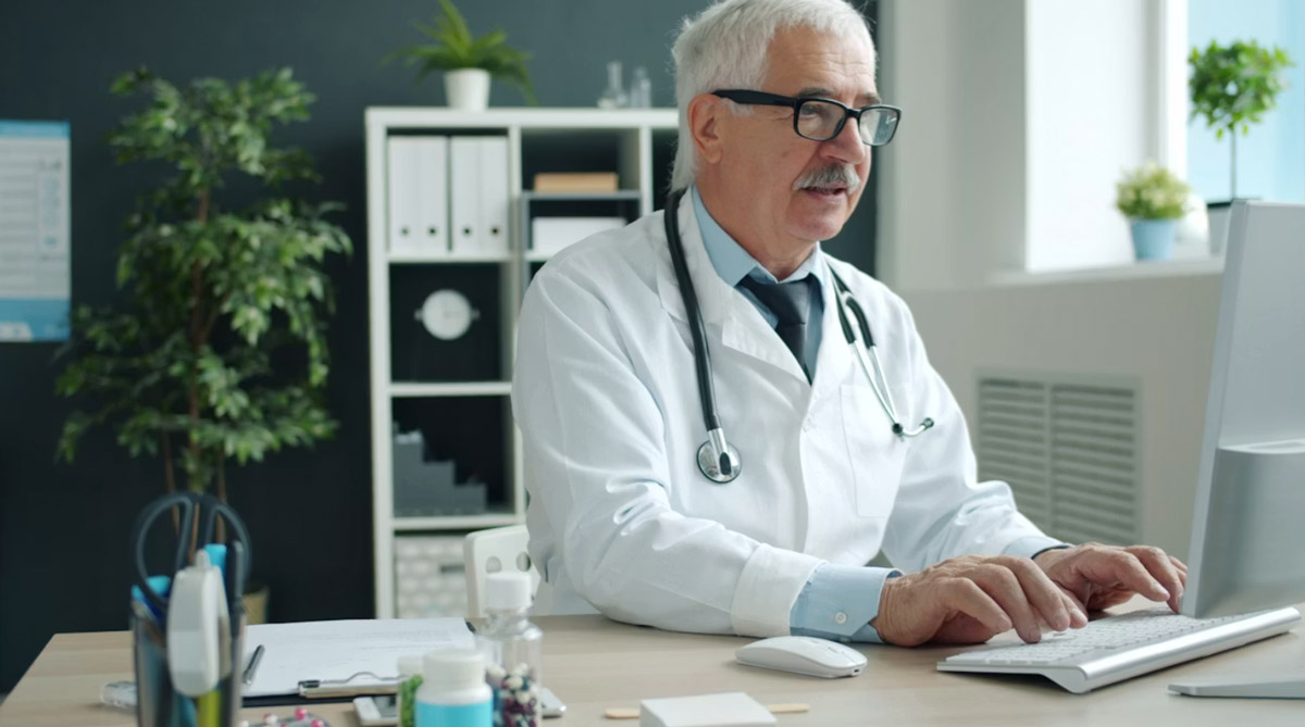 A physician entering and reviewing quality data on a clinic computer
