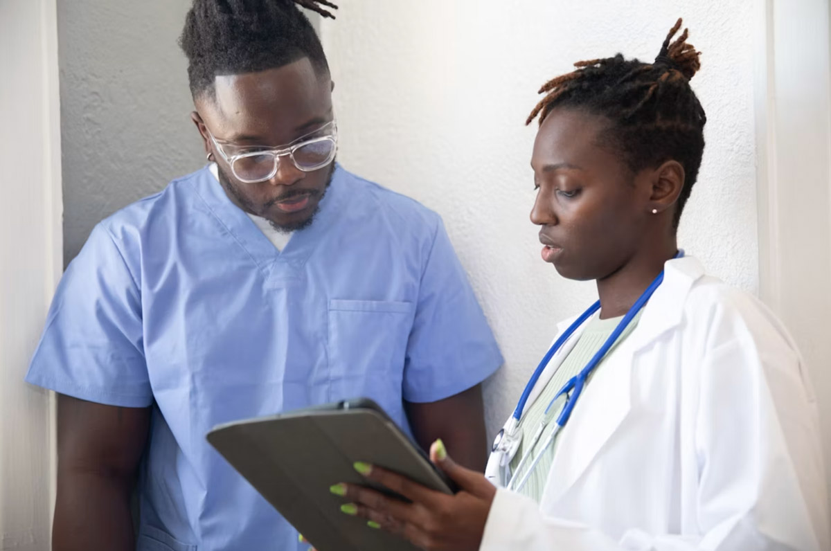 Close-up of a physician reviewing information on a tablet