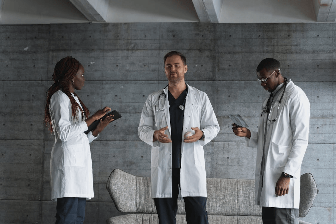men in white coat standing beside woman in white coat