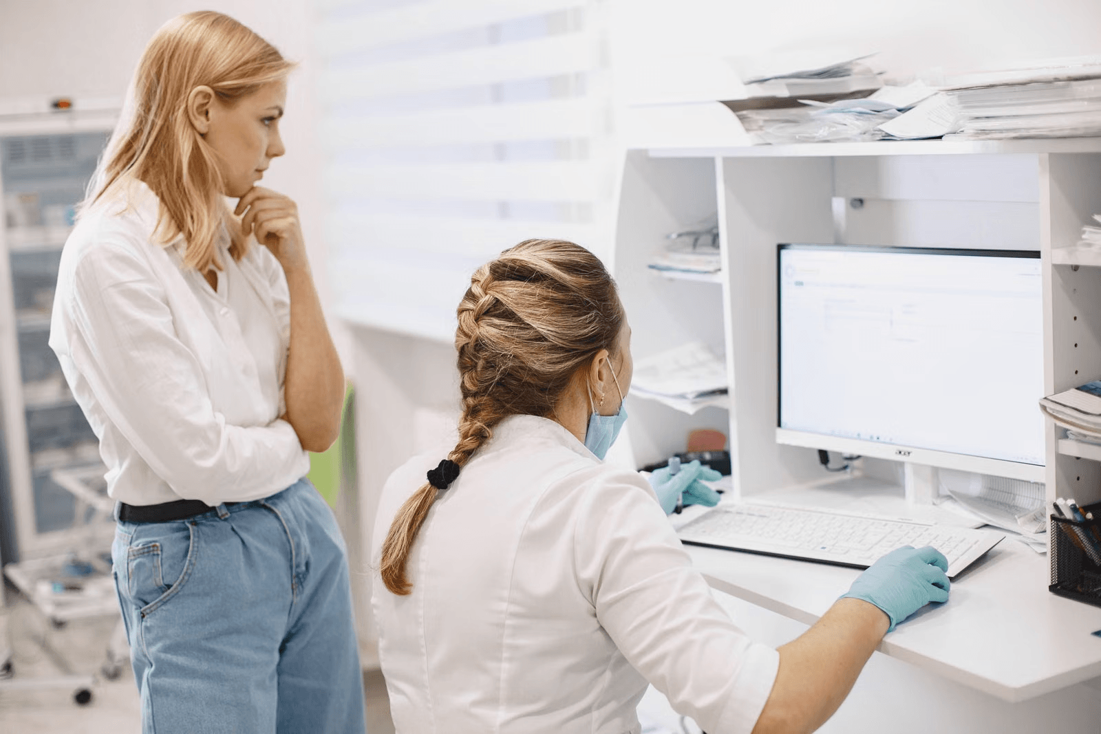 Healthcare workers reviewing patient data on a computer screen