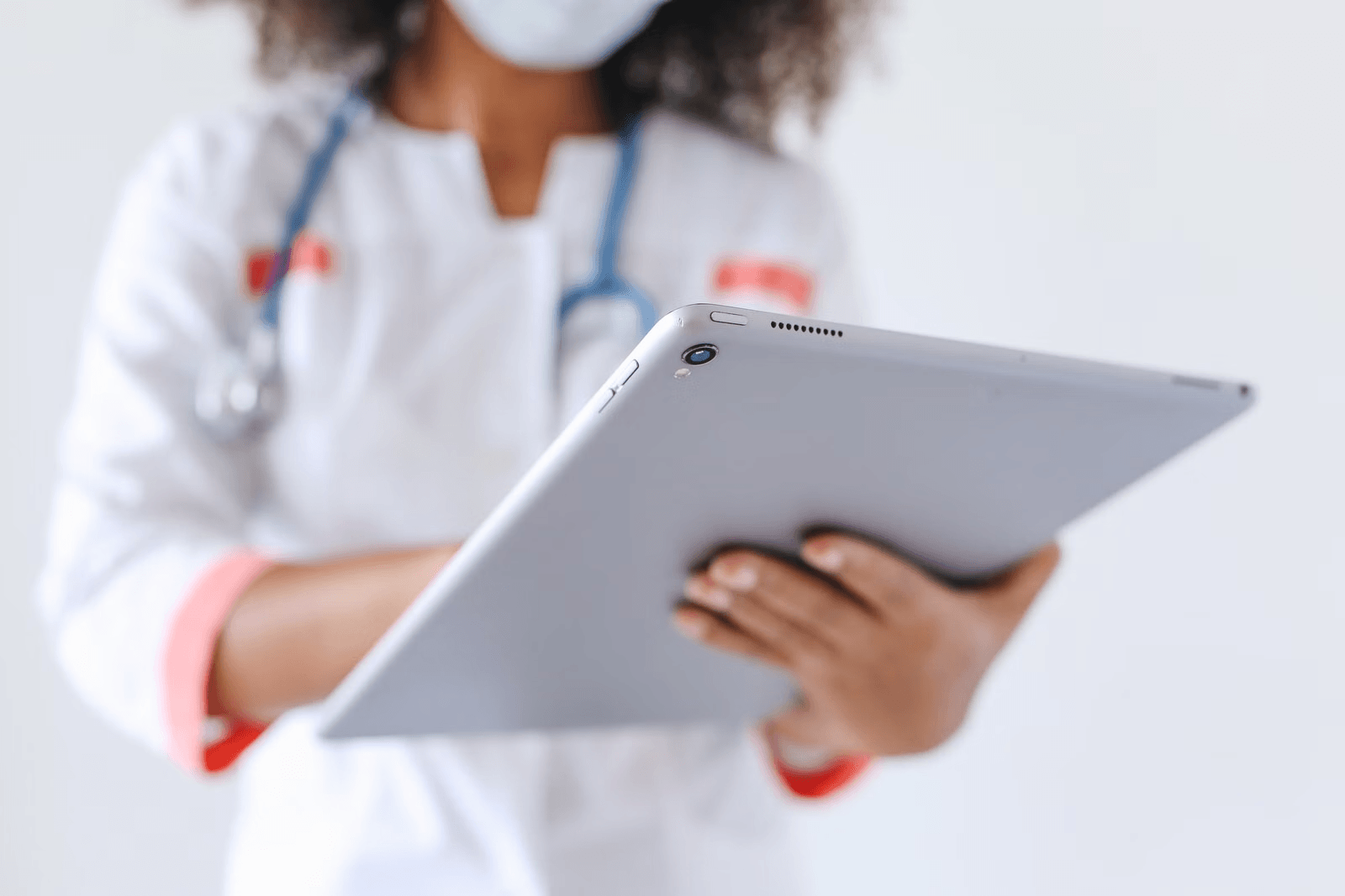 Doctor using a tablet to review patient information in a clinic
